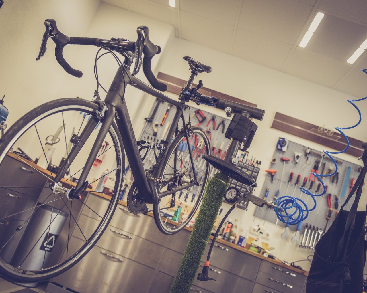 Bicycle in a workshop for maintenance and safety control.